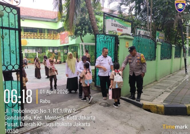 
					Humanis dan Sigap, Bhabinkamtibmas Gondangdia Kawal Siswa SDN Gondangdia 03 di Jam Sibuk Pagi